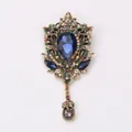 Vintage palace style brooch with a large blue teardrop crystal and colorful rhinestones. - Dark Blue
