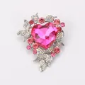 Detailed macro shot of a luxurious pink heart crystal brooch with sparkling rhinestones. - Pink
