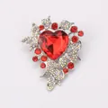 Luxurious silver-tone heart-shaped brooch featuring vibrant red crystals and rhinestones - Red