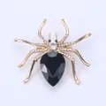 Elegant golden spider brooch with large black pear-shaped gemstone and white crystals - Black