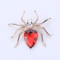 Exquisite spider brooch featuring a large red pear-cut gemstone and sparkling white rhinestones - Red