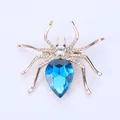 Creative rose gold spider brooch featuring a large blue drop crystal and white rhinestones - Blue
