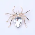 Elegant gold-colored spider brooch featuring sparkling rhinestones and pear-cut crystal - Gold Base White