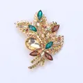 Elegant gold-tone leaf bouquet brooch embellished with colorful glass rhinestones. - Champagne