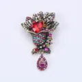 Vintage colorful rhinestone brooch with dangling teardrop pendant and antique gold finish - S1 Red Main Stone