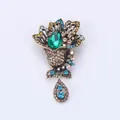 Exquisite vintage style brooch featuring a green teardrop crystal and colorful rhinestones. - S2 Green Main Stone