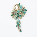 Vintage style tassel brooch with green and amber rhinestones on a white background - Light Green