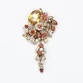 Elegant vintage tassel brooch featuring amber rhinestones and glass flower details - Champagne