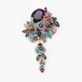Vintage floral tassel brooch featuring purple and turquoise rhinestones in gold setting - Purple
