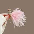Elegant golden flamingo brooch featuring delicate pink feathers and a crystal drop pendant - Flamingo-Pink Feather