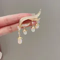 Detailed view of lily of the valley brooch with crystal tassels and white pearls - Gold
