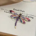 Close-up of elegant enamel dragonfly brooch with colorful wings and rhinestones - Purple Enamel Dragonfly