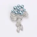 Elegant floral bow brooch featuring light blue imitation pearls and sparkling clear rhinestones - Silver Base Blue Pearl / Bow Flower Style (8646)