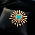 Detail of a vintage baroque brooch with matte gold rays and turquoise center stone. - Baroque Sunburst Style (A4-4-5255) / Matte Gold (A4-4-5255)