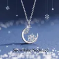 Dreamy crescent moon and snowflake pendant necklace with blue crystals in silver finish - Snowflake
