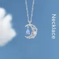 Elegante zilveren ster en maan ketting met een lichtblauwe kristallen waterdruppel - Geschenkdoos / Vluchtige Maan op het Water