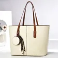 Front view of large cream tote bag with brown straps and circular pouch charm - Off White
