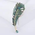 Vintage gold feather brooch pin with teal rhinestones and green teardrop stone - Green