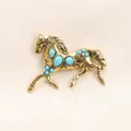 Vintage gold-tone horse brooch with faux turquoise inlays for coats and jackets accessories - Gold