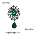Vintage emerald green crystal brooch with silver alloy base and rhinestone detailing. - Green