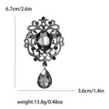 Vintage alloy crystal brooch featuring a grey teardrop pendant and detailed rhinestone inlay. - Gray