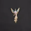 Detail of a vintage hummingbird brooch with vibrant purple and blue rhinestones. - Blue And Purple Gradient Gold Base