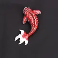 Elegant red and white koi fish brooch with sparkling rhinestones on dark textured fabric - Red and White Koi (K2-3-2244)