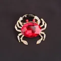 Elegant gold-toned crab brooch featuring a large faceted red crystal and clear rhinestones - Red Main Stone Gold Crab