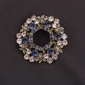 Elegant vintage unisex floral wreath brooch pin featuring blue and purple crystal accents - Bronze Dark Blue Wreath