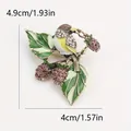 Vintage bird brooch with rhinestones and enamel leaves, measuring 4.9cm by 4.0cm - Pink Berry Branch Bird (Q6-1-7268)