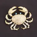 Sparkling gold-plated crab brooch featuring crystal rhinestones and blue stone eyes - AB Rhinestone Gold Crab