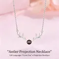 Detail view of a silver reindeer antler necklace with a 100 languages projection stone - Antler Style (Simple Packaging)