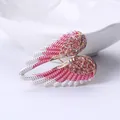 Elegant angel wing brooch embellished with pink rhinestones and silver-white enamel finish - Pink Silver