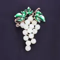 Elegant grape shaped brooch with green enamel leaves and white beads on black background - Rice White (Grape Shape)