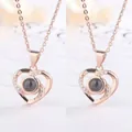 Elegant rose gold heart-shaped projection necklace with shimmering crystal accents. - 2 Pieces/Pack (Simple Packaging) / Rose Gold