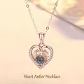 Close-up of rose gold heart necklace with reindeer antlers and projection stone - Antler Heart / Simple Packaging