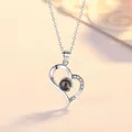 Close-up of a silver heart pendant necklace featuring a 100-language projection stone. - Heart Projection / Simple Packaging