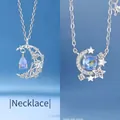 Elegante zilveren sterren- en maanketting met een stralende blauwe maansteen hanger - Zwevende Maan en Sterren Rond de Maan / Eenvoudige Verpakking