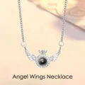 Detailed view of silver-tone angel wings projection necklace with stone pendant - Wings Projection / Simple Packaging