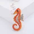 Elegant orange enamel seahorse brooch featuring white pearl bubbles and glitter accents - Orange Enamel Pearl (b6-3-6438)