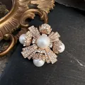 Detailed view of a vintage baroque cross brooch with pearls and sparkling crystals - Cross Pearl Rhinestone Style
