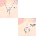 Macro view of silver moonstone necklaces featuring celestial moon and snake motifs with pink gems - Moon & Snake Moon (Style 5) / Two-Piece Set