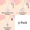 Set of three necklaces featuring moon, planet, and dreamcatcher designs in silver finish - 3-Piece Set (Moon & Planet & Dreamcatcher B)