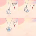 Detail view of a 3-piece silver necklace set featuring moon, snowflake and heart pendants - Three-Piece Set / Silver-Set 10