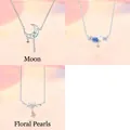 Detail view of 3-piece silver necklace set with moon, flower, and pearl designs - 3-Piece Necklace Set 7 / Set of 3