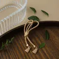 Vintage matte gold twisted rope brooch with tassel detail in baroque style - Rope Tassel Style