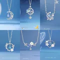 Elegante zilveren kettingvarianten met hangers van maan en bloemen in blauwe tint - Maan + Sterrenstelsel + Sterren + Vlinder + Bloem + Hart / Geschenkdoos