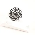 Elegant close-up of a hollow rose brooch featuring shimmering black rhinestones. - Black