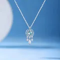 Detailed shot of a silver dreamcatcher necklace with a blue stone and crystal charms - Dream Catchers