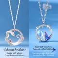 Elegant silver necklaces with crescent moon snake and blue mermaid tail pendants - Snake Moon + Fish Tail Style